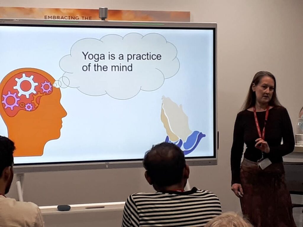 Penelope teaching yoga as a mindful practice of the mind and body.