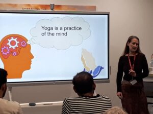 Penelope teaching yoga as a mindful practice of the mind and body.